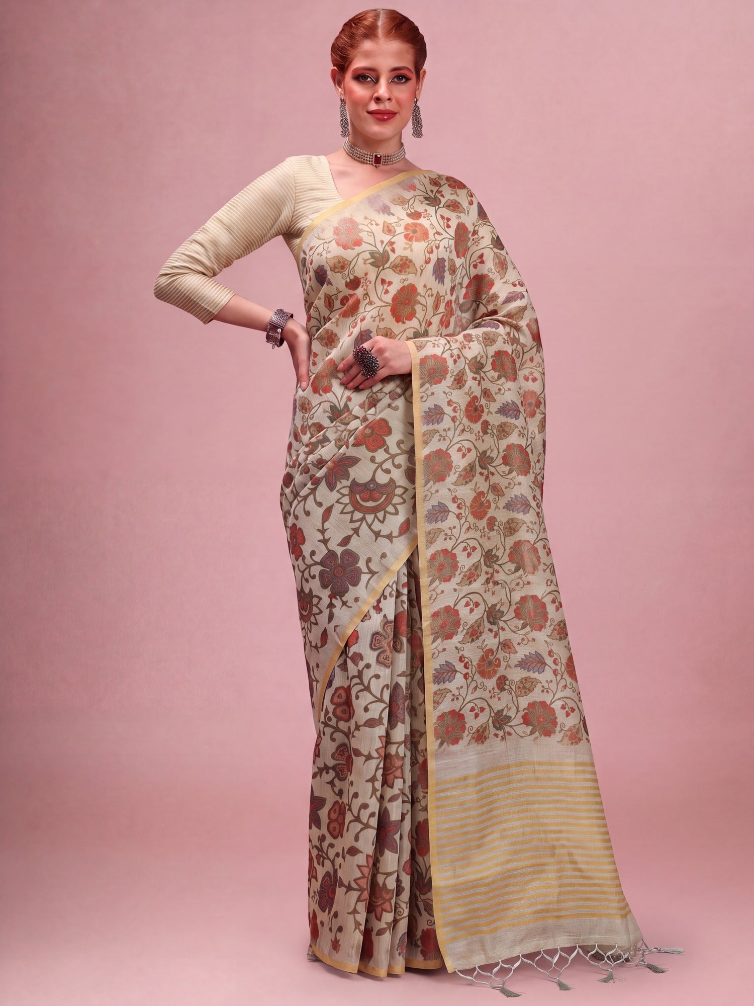 Woman wearing beige tissue saree with botanical floral and leaf design and beige blouse