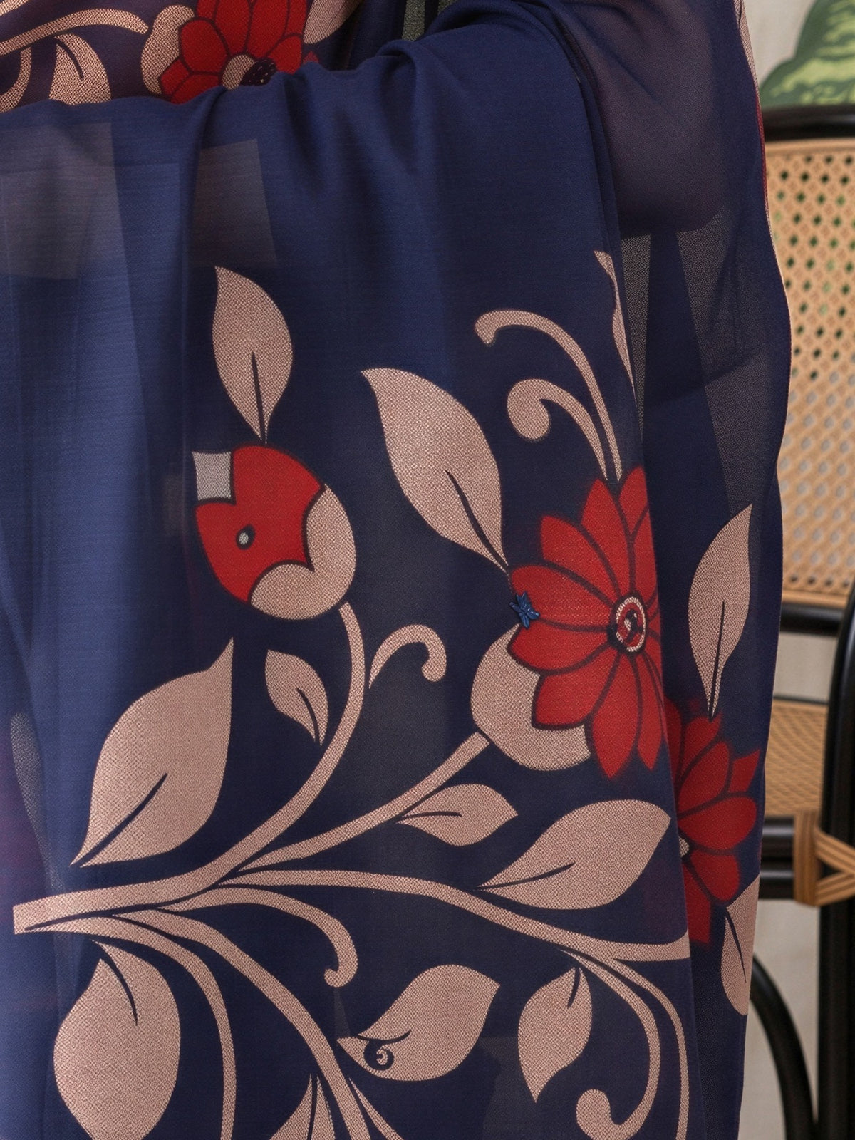 Pallu detail of navy blue linen blend saree showing all-over floral design and printed border