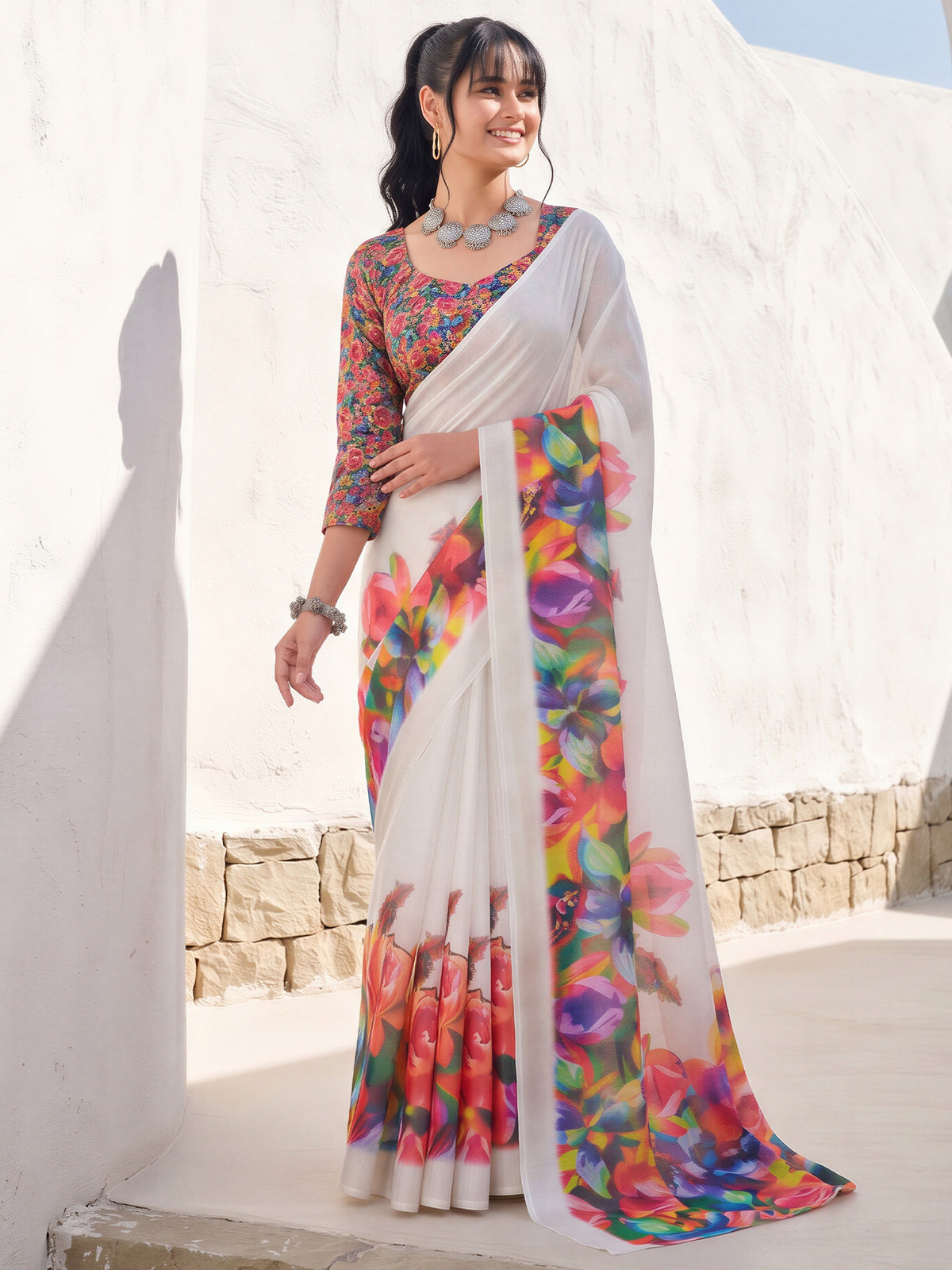 Woman wearing white cotton linen saree with all-over floral design and multicolored blouse