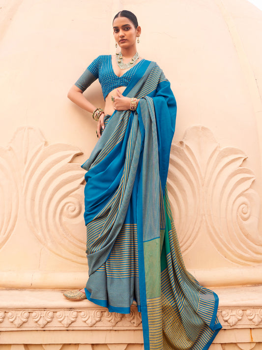 Woman wearing teal blue silk blend saree with striped pattern design and teal blue blouse