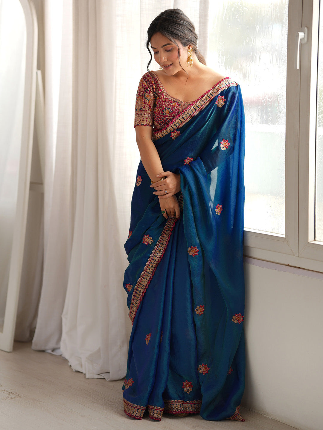 Rich royal blue color with elegant floral embroidery.
Designer embroidered border enhances the festive look.