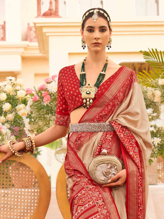 Beige Zari Woven Silk Blend Saree with Red Patola Borders