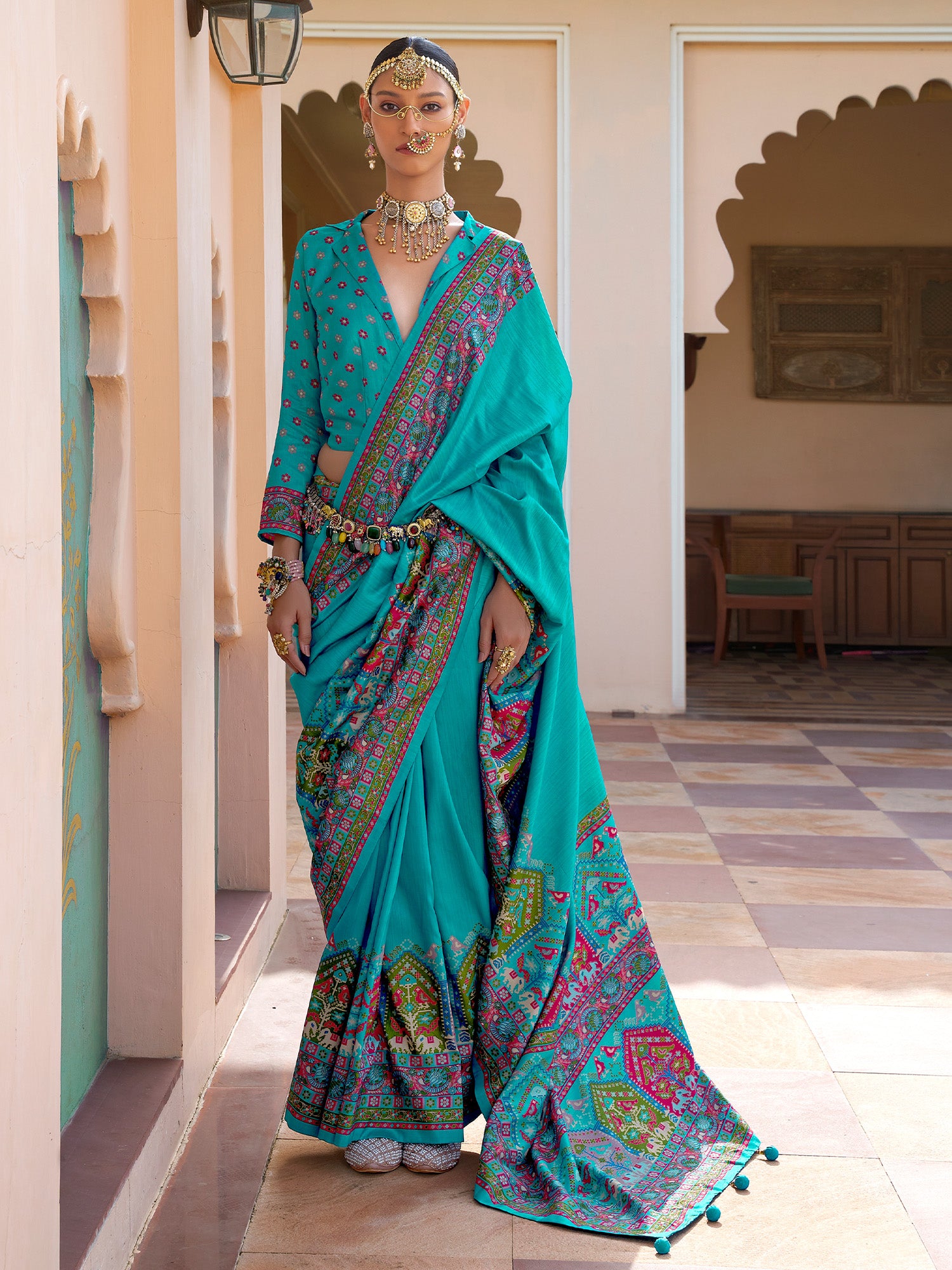 Teal Patola silk saree with elephant and floral motifs, multicolor Patola border and tassels,