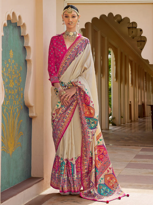 Ivory Patola silk saree with elephant and floral motifs, multicolor Patola border and tassels, worn by model