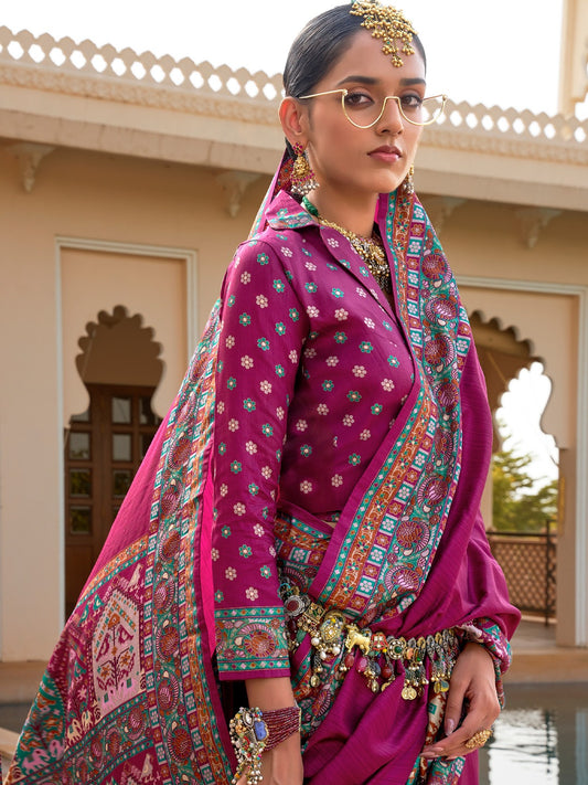 Magenta Patola silk saree with elephant and floral motifs, multicolor Patola border and zari butta work with tassels, worn by model with full-sleeve matching blouse