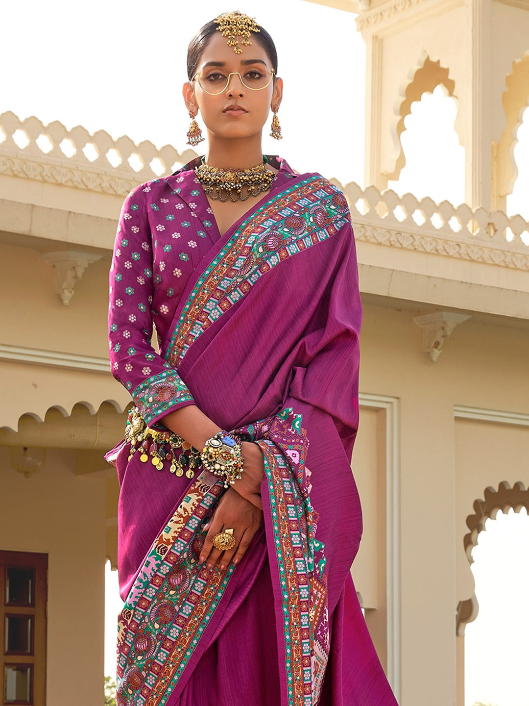 Magenta Patola silk saree with elephant and floral motifs, multicolor Patola border and zari butta work with tassels, 