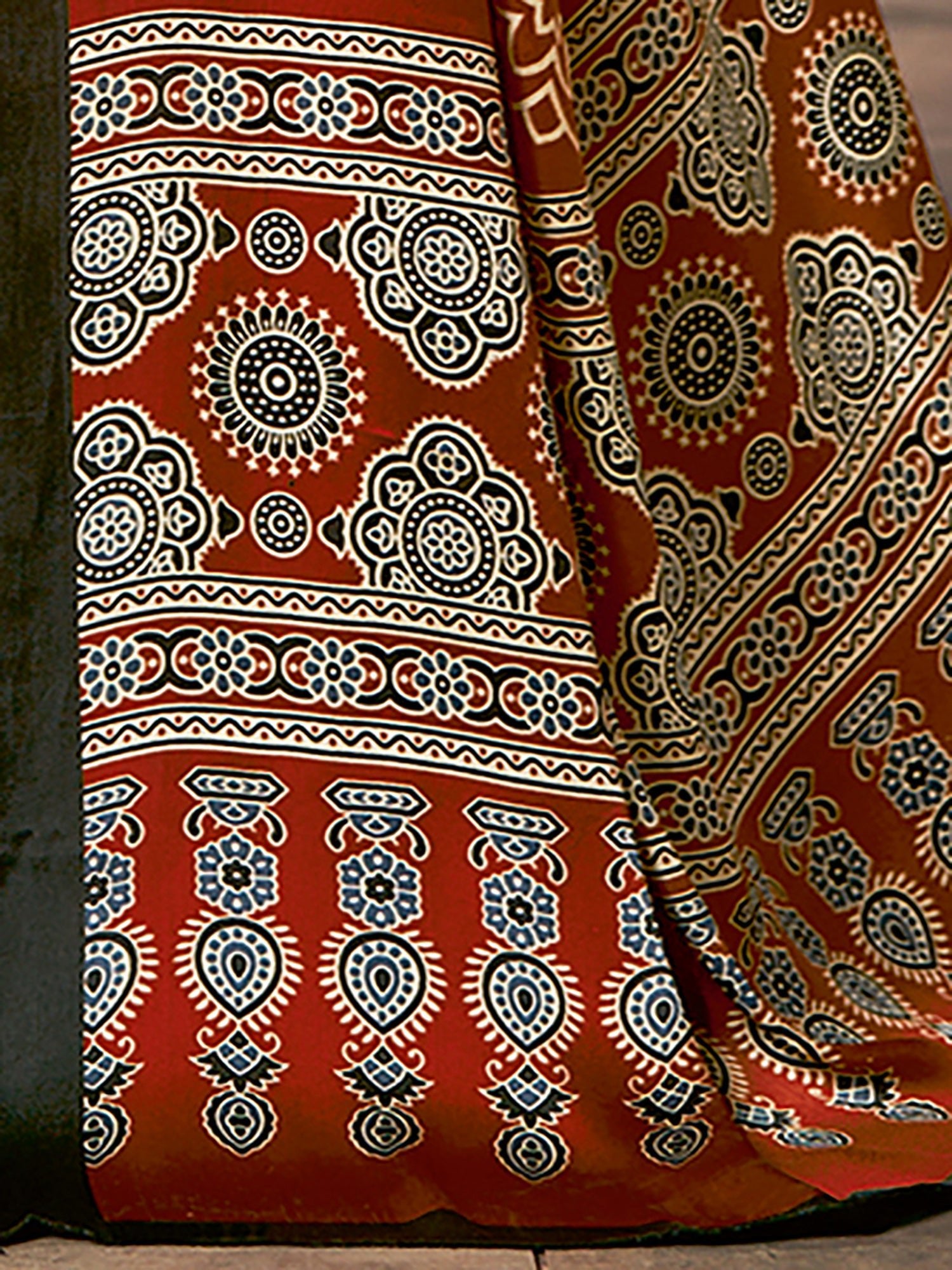 Rust Red Ajrakh Silk Saree with Geometric Sun Medallions, Paisley Buttas & Black Blouse - Ressa
